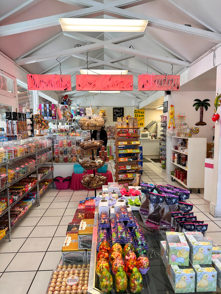 The interior of Palm Springs Fudge & Chocolates in Palm Springs, showing numerous plastic bins full of colorful candy.