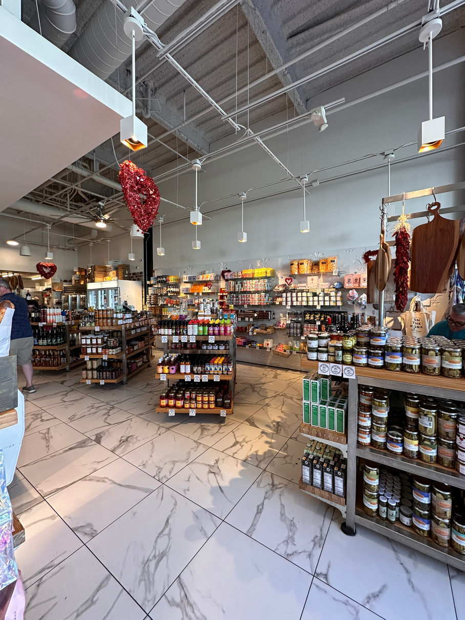 Interior of On the Mark deli/market in Palm Springs, showing aisles of gourmet goods.