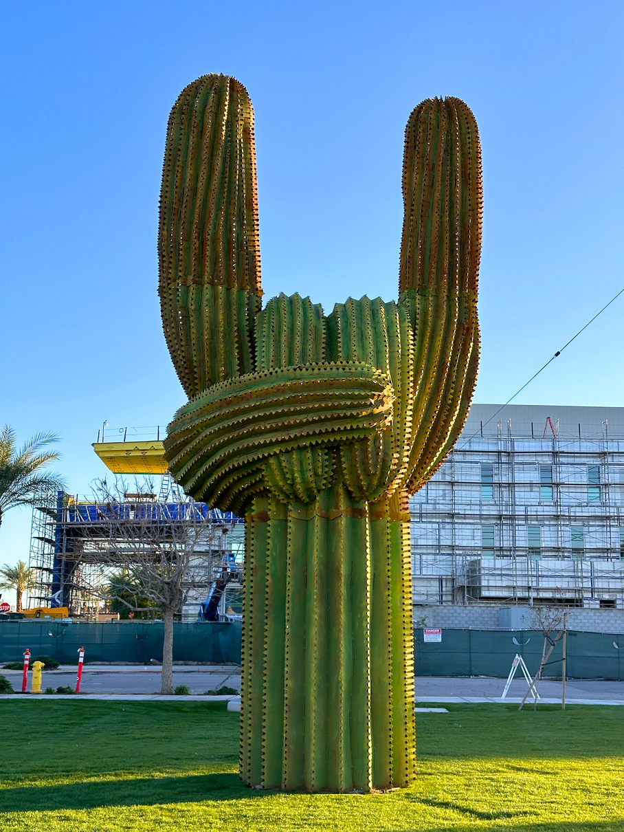 The saguaro cactus-inspired "Heavy Metal" statue with its branches folded into a "rock on" salute in downtown Indio.