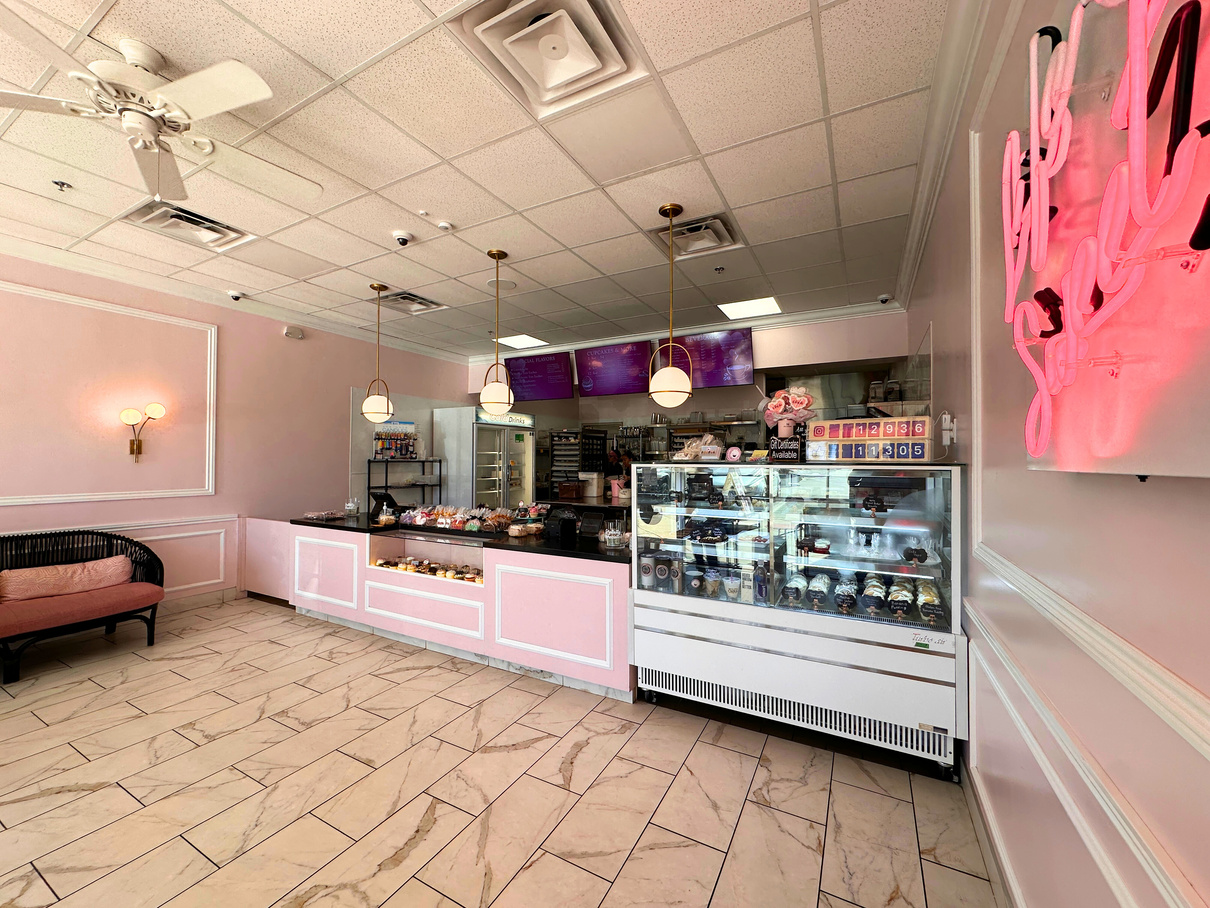 The sales counter at Tiffany's Sweet Spot in La Quinta, complete with pink walls and a neon sign.