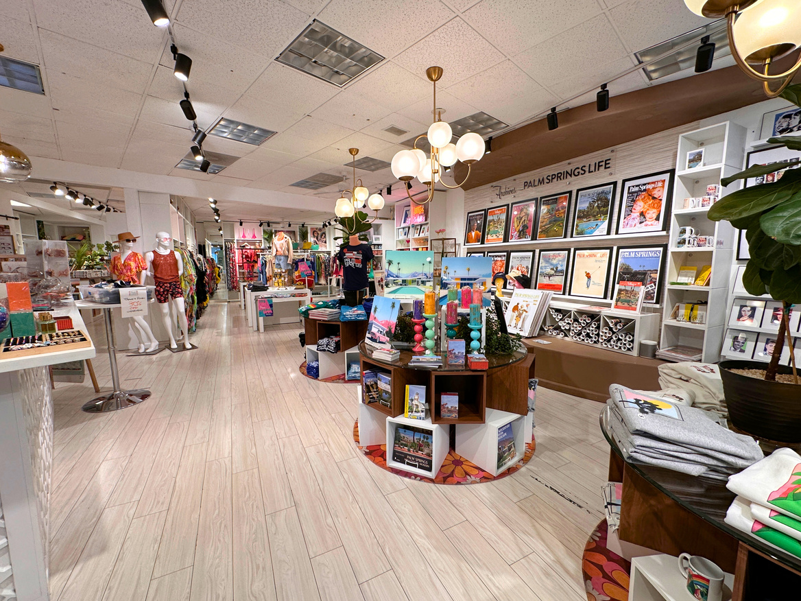 Interior of Peepa's, an upscale gift shop in Palm Springs, showing vintage clothing, art work and t-shirts for sale.