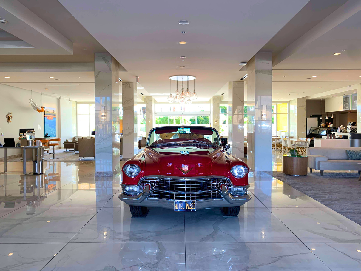 The lobby area of Hotel Paseo in Palm Desert complete with a retro car on display.